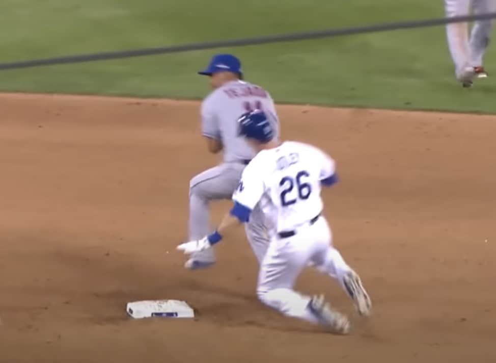 Chase Utley slides into second base, sparking debate over MLB rules and player safety.